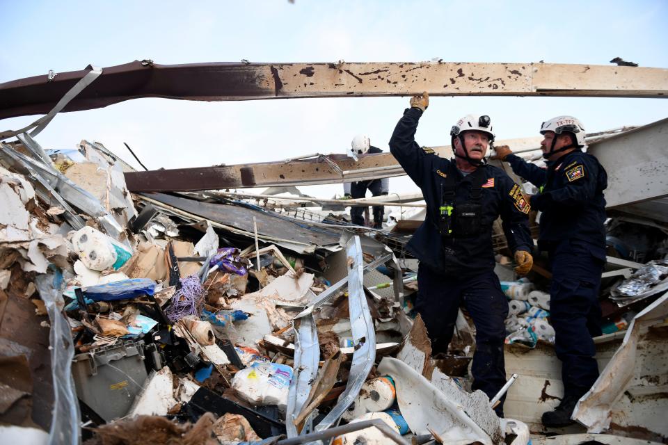 Search and rescue teams look for survivors in a former Dollar General after a tornado, Thursday, June 22, 2023, in Matador, Texas. 