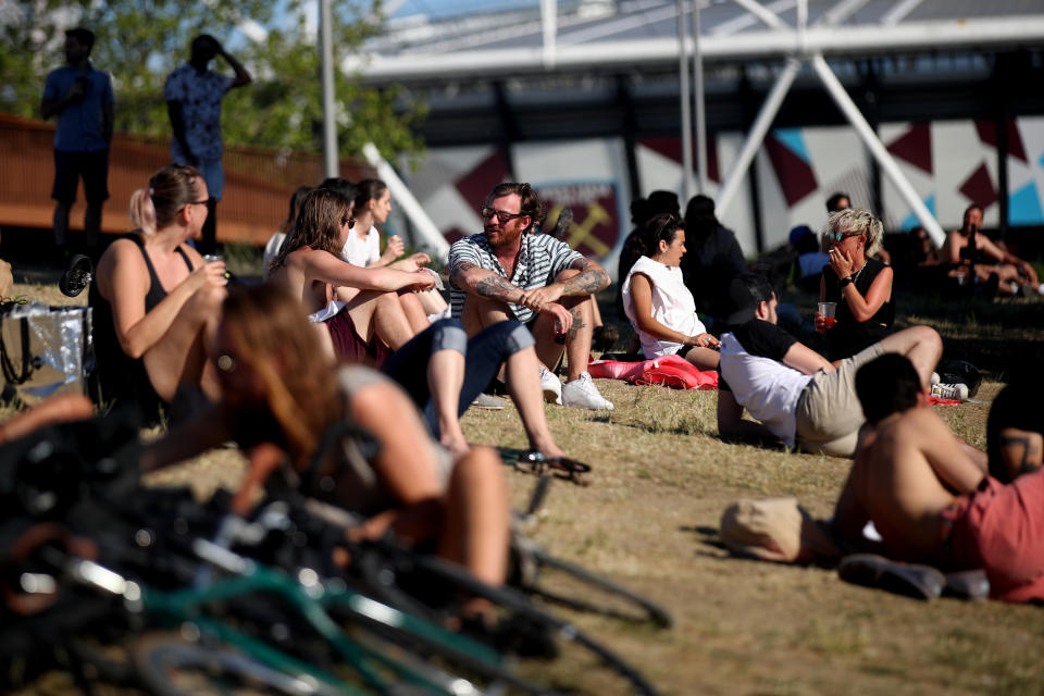 LONDON, ENGLAND  - MAY 31: People enjoy the sun in Hackney Wick on May 31, 2020 in London, England. The British government continues to ease the coronavirus lockdown by announcing schools will open to reception year pupils plus years one and six from June 1st. Open-air markets and car showrooms can also open from the same date.  (Photo by Alex Pantling/Getty Images)