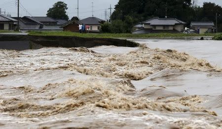 A view of flood waters from the Kinugawa river (R) caused by typhoon Etau at a residential area in Joso, Ibaraki prefecture, Japan, September 10, 2015. REUTERS/Issei Kato