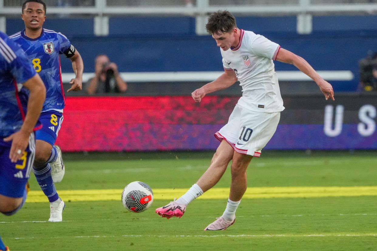 Jun 11, 2024; Kansas City, Kansas, USA; United States forward Taylor Booth (10) kicks a shot on goal against Japan during the first half at Children's Mercy Park. Mandatory Credit: Denny Medley-USA TODAY Sports