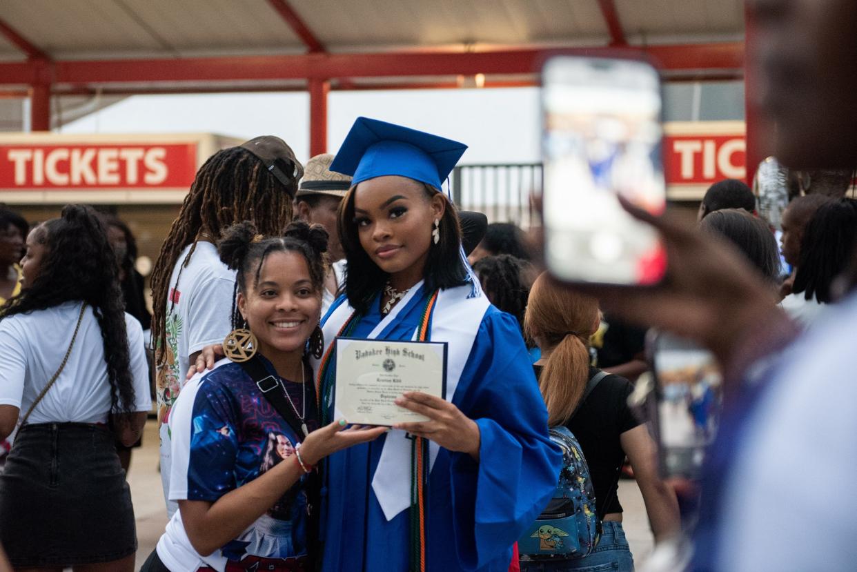 Pahokee graduate Kristian Kidd shows off her diploma while posing for a picture alongside Ulecia Boldin after the end of the Pahokee Class of 2023 high school graduation ceremony on Tuesday, May 23, 2023, at the South Florida Fair in West Palm Beach, Fla.