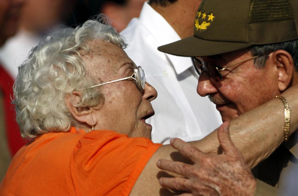 FILE - In this July 26, 2010 file photo, Melba Hernandez, left, greets Cuba's President Raul Castro at a Revolution Day rally in Santa Clara, Cuba. Hernandez, who died on Sunday, March 9, 2014, helped found the Communist Party of Cuba and served as ambassador in Vietnam and Cambodia. She was 92. (AP Photo/Javier Galeano)