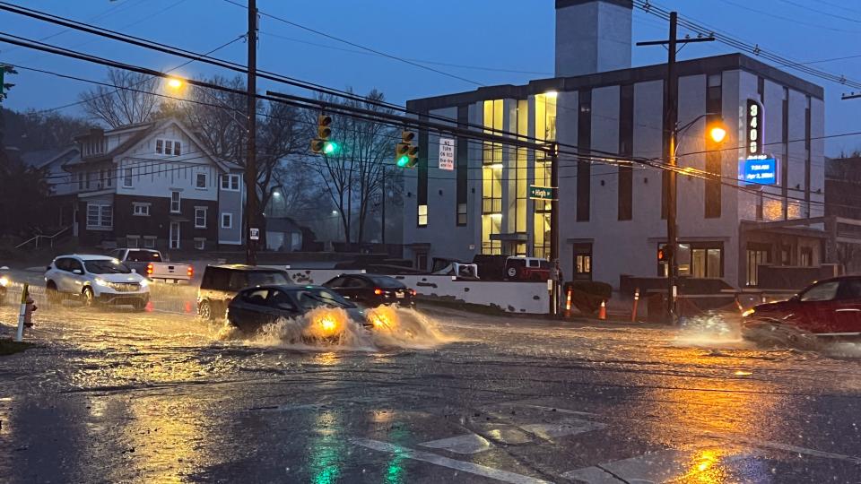 Cars navigate a flooded intersection at N. High St. and North Broadway St. in Columbus, Ohio.