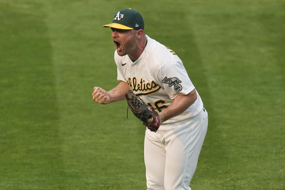 Oakland Athletics relief pitcher Liam Hendriks celebrates after striking out Chicago White Sox's Nomar Mazara for the final out of Game 3 of an American League wild-card baseball series Thursday, Oct. 1, 2020, in Oakland, Calif. The Athletics won 6-4. (AP Photo/Eric Risberg)