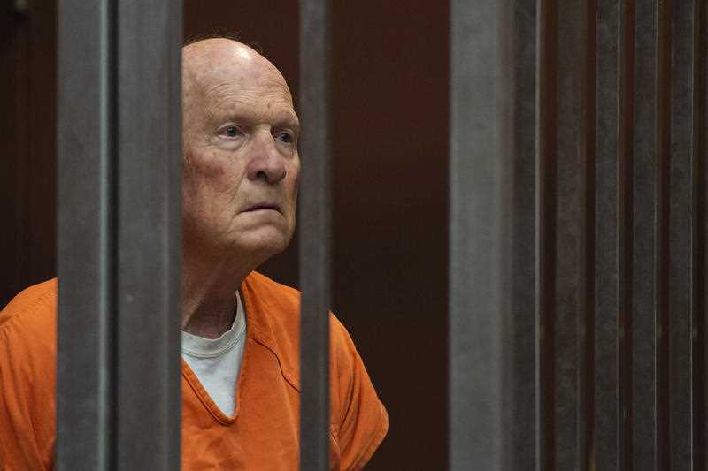 Joseph James DeAngelo stands in a jail cell.