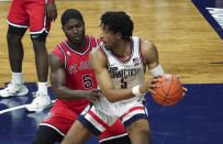 St. John's guard Dylan Addae-Wusu, front left, pressures Connecticut forward Isaiah Whaley, right, in the second half of an NCAA college basketball game in Storrs, Conn., Monday, Jan. 18, 2021. (David Butler II/Pool Photo via AP)