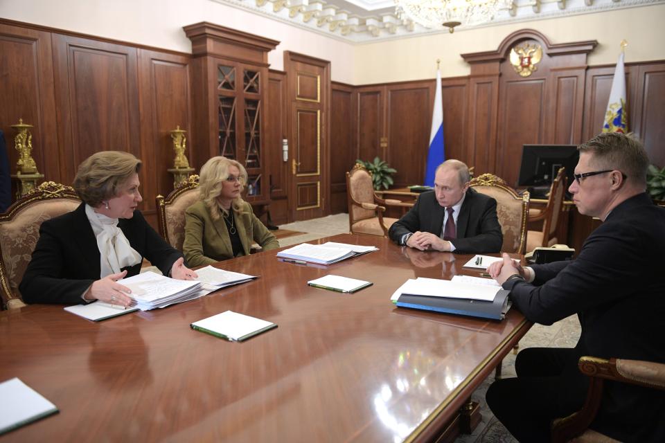 Russian President Vladimir Putin, second right, chairs a meeting on preventing the spread of coronavirus in Moscow, Russia, Wednesday, Jan. 29, 2020. Putin has urged the country's government to "be prepared" for dealing with a possible outbreak of the new virus Wednesday. (Alexei Druzhinin, Sputnik, Kremlin Pool Photo via AP)