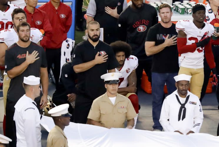 San Francisco 49ers quarterback Colin Kaepernick's recent decision to not stand during the national anthem as a way of protesting police killings of unarmed black men has drawn support and scorn far beyond sports.