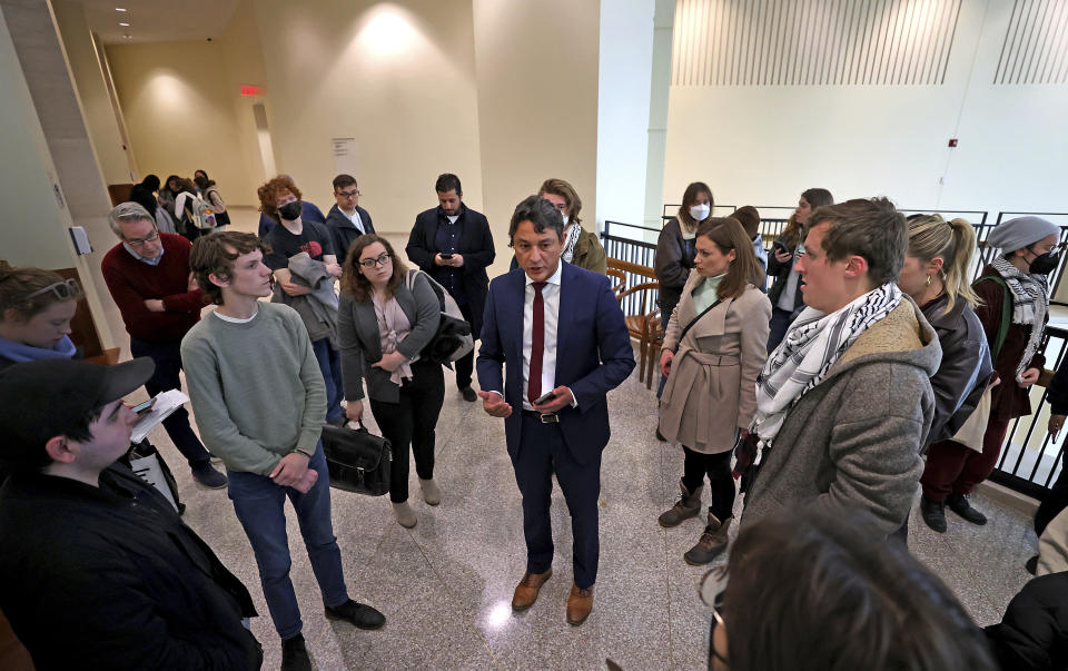 FILE- Attorney Antonio Massa Viana with National Lawyers Guild representing students speaks as Emerson students appeared in court for an arraignment on Thursday, April 25, 2024 in Boston. Protest camps have sprouted up over the past two weeks at dozens of campuses across the nation. Some schools have set up encampments on campuses, including Emerson. Others like Boston College have been calm. (David L Ryan/The Boston Globe via AP)