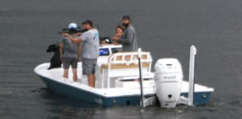 A boater recently takes a shot with a rifle toward the shore at Lake Osborne in unincorporated Palm Beach County. Residents of nearby Lake Osborne Estates have called on the Palm Beach County Sheriff's Office to investigate.