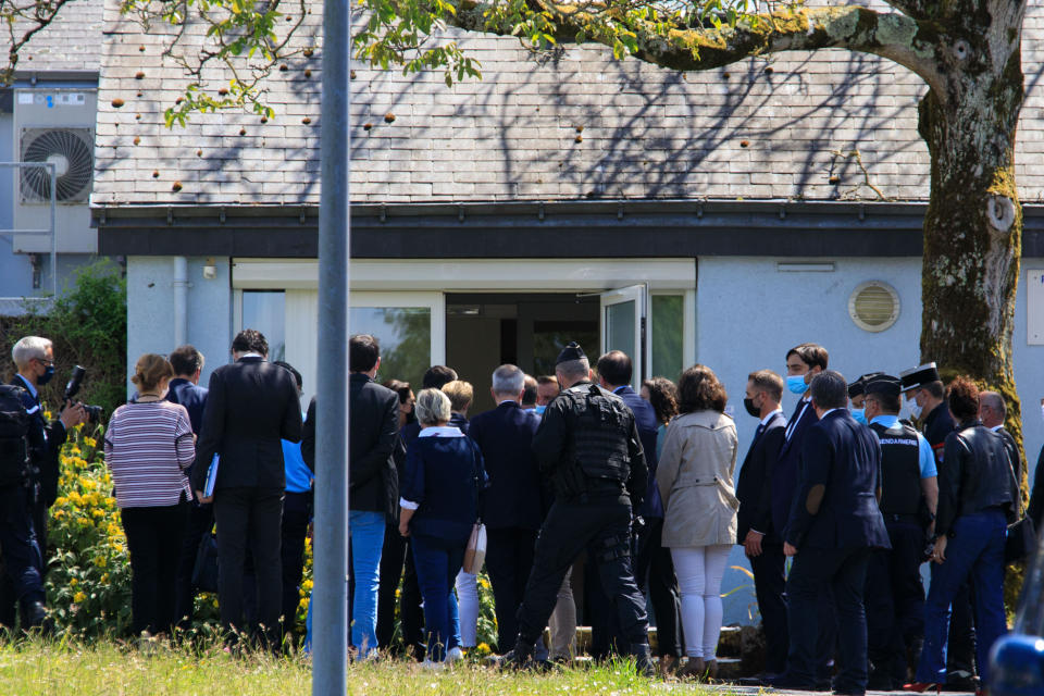 Police officer and officials gather at the police station in La Chapelle-sur-Erdre, France, Friday, May 28, 2021. An unidentified assailant stabbed a police officer at her station Friday in western France then shot two other officers before being killed in a shootout with police, authorities said. (AP Photo/Laetitia Notarianni)