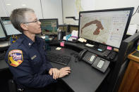 CORRECTS SPELLING OF FIRST NAME TO DANELL, NOT DANELLE - Cal Fire Capt. Danell Eshnaur uses the Fire Response Tactical Analyst program to use computer modeling to help pre-position fire fighting resources on the Dixie Fire at the California Department of Forestry and Fire Protection's Sacramento Command Center in Rancho Cordova, Calif., Friday, July 23, 2021. Firefighters are trying to become smarter in how they prepare for the drought- and wind-driven wildfires that have become more dangerous across the American West in recent years, including by using new technology like fire behavior computer modeling that can help assess risks before fires start, then project their path and growth. (AP Photo/Rich Pedroncelli)