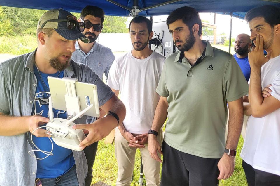 Cameron Barnes, a recent MTSU Unmanned Aircraft Systems Operations graduate, shows members of the Dubai Police Force students participating in the Business Analytics and Forensic Science Global Study program at Middle Tennessee State University in August how the controls work on one of the university’s drones.