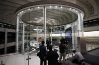 Members of media film a stock trading floor at Tokyo Stock Exchange Thursday, Oct. 1, 2020, in Tokyo. The Tokyo Stock Exchange temporarily suspended all trading due to system problem. (AP Photo/Eugene Hoshiko)