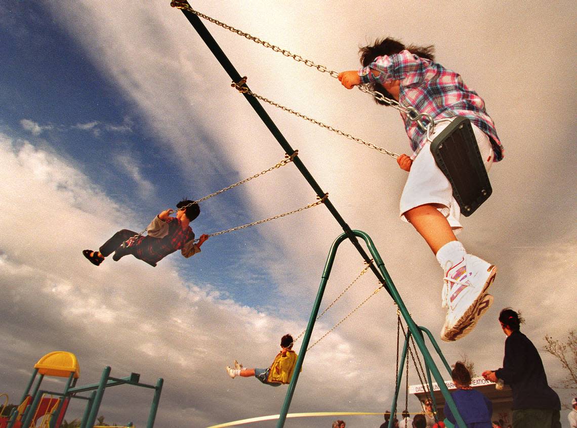 Children play on a playground named for civic activist Leona Ferguson Cooper at the The Women’s Park on West Flagler Street in Miami in March 1996.