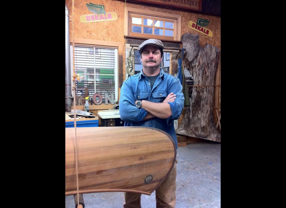 In this February 2012 image released by Jessica Glazer, Nick Offerman, who plays Ron Swanson on NBC's "Parks & Recreation," stands next to one of two canoes he built as shown in his Woodworking Studio in Los Angeles. Building boats requires a particular kind of commitment. It's complex and expensive. It can take months or years. And it can be addictive, working out in the garage, sawdust clinging to your clothes, making mistakes and finding the solutions yourself. (AP Photo/Jessica Glazer)