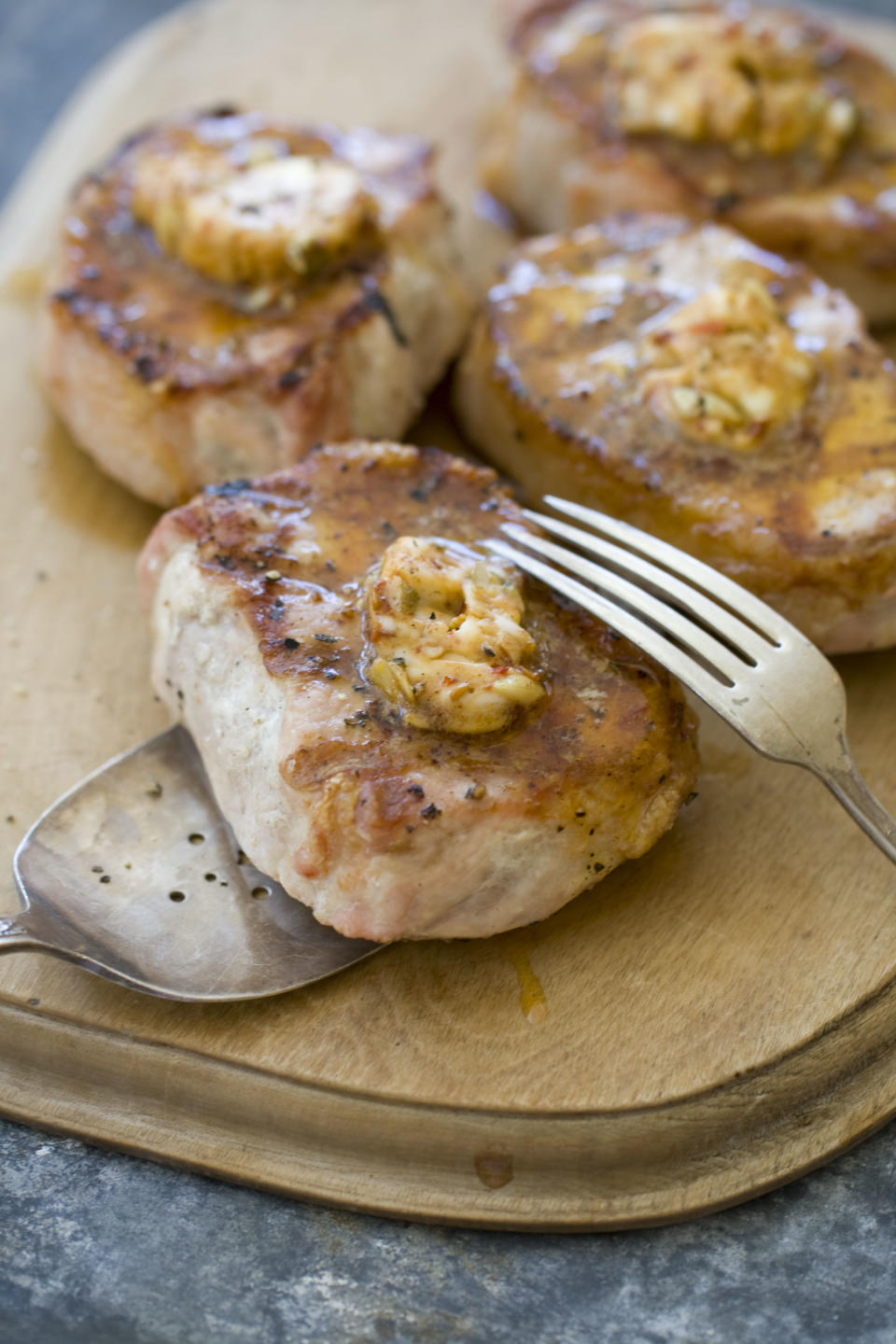 This Sept. 30, 2013 photo shows pork chops with chipotle pumpkin seed butter in Concord, N.H. (AP Photo/Matthew Mead)