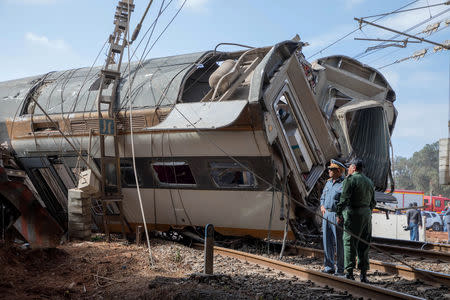 Security personnel stand at the site of a train derailment at Sidi Bouknadel near the Moroccan capital Rabat, Morocco, October 16, 2018. REUTERS/Youssef Boudlal