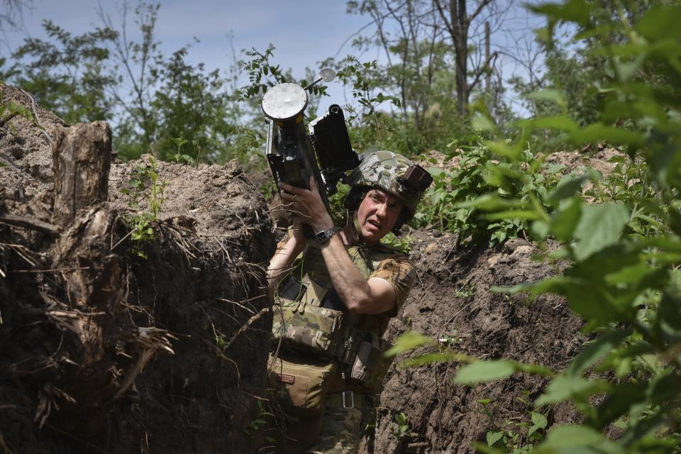 FILE - A Ukrainian serviceman carries a U.S. Stinger air-defense missile launcher on the front line in the Zaporizhzhia region of Ukraine, on Tuesday, May 28, 2024. Russian troops are forging through Ukraine's defenses along the front line in a relentless onslaught this summer, prompting the West to push for new weapons and strategies to shore up Kyiv. (AP Photo/Andriy Andriyenko, File)