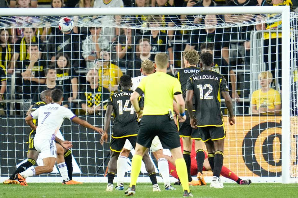 May 13, 2023; Columbus, Ohio, USA;  Orlando City forward Duncan McGuire (13) scores Orlando City’s second goal of the game while defended by Columbus Crew goalkeeper Patrick Schulte (28) during the second half of the MLS soccer game between Columbus Crew and Orlando City at Lower.com Field.