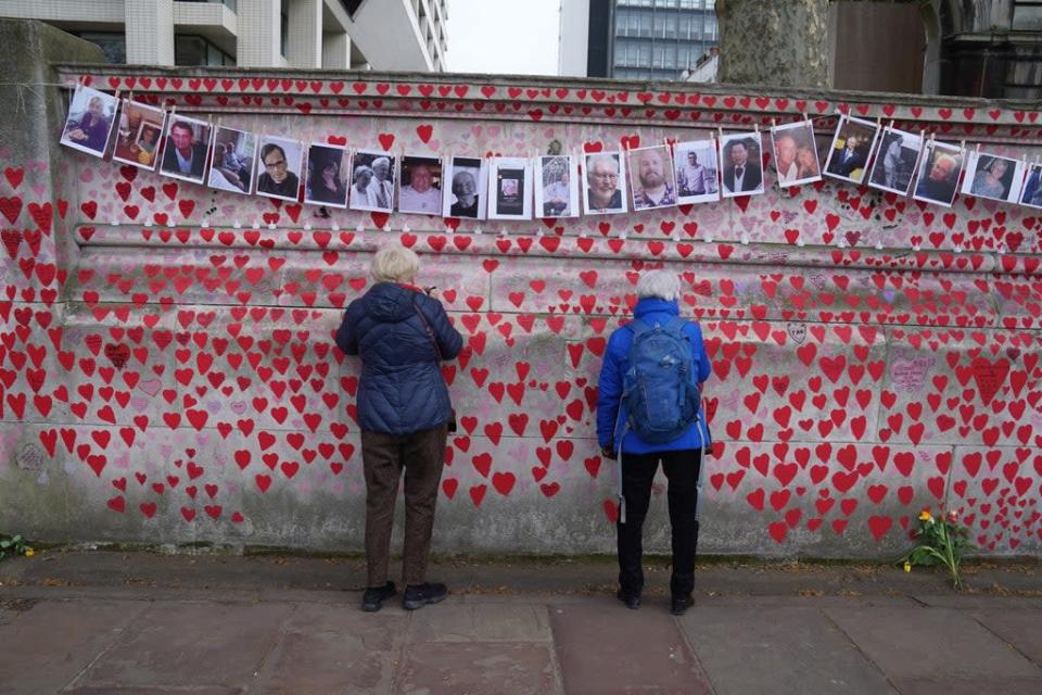 Bereaved families by the Covid memorial wall in central London (Stefan Rousseau/PA) (PA Wire)