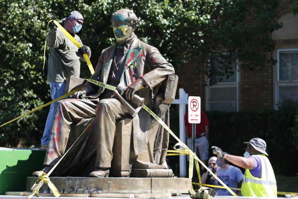 FILE - Workers secure the statue of Confederate Naval officer Matthew Fontaine Maury to a truck on Monument Avenue, Thursday, July 2, 2020, in Richmond, Va. A Virginia special prosecutor has found no wrongdoing in the awarding of a $1.8 million contract for the removal of Richmond's Confederate statues last summer. The prosecutor said in a news release Wednesday, July 28, 2021, that he had reviewed the findings of a state police investigation and found no criminal activity. (AP Photo/Steve Helber, File)