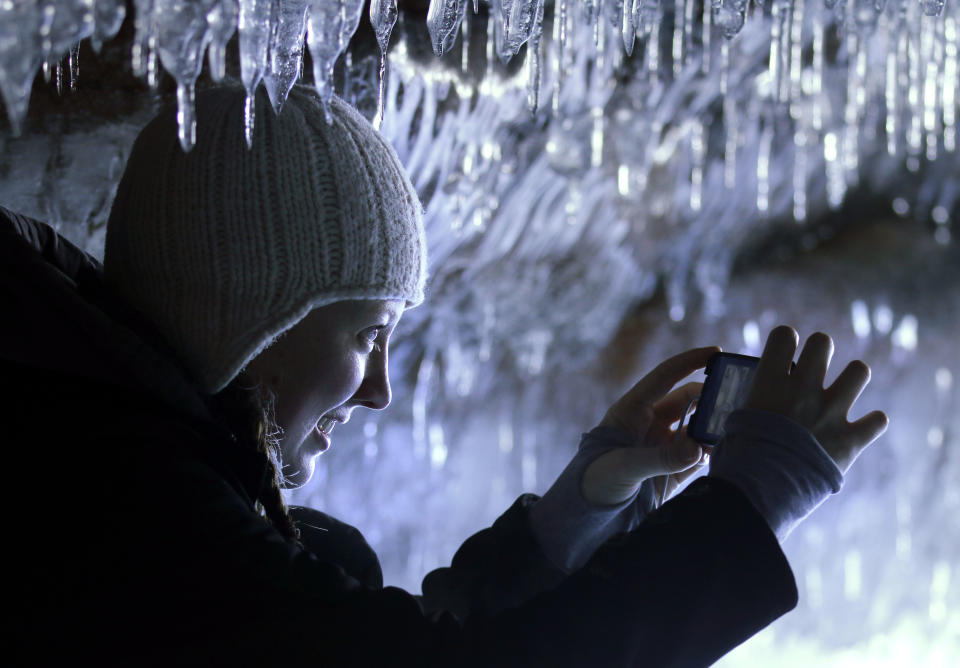 In this Feb. 2, 2014 photo people visit the caves at Apostle Islands National Lakeshore in northern Wisconsin, transformed into a dazzling display of ice sculptures by the arctic siege gripping the Upper Midwest. The caves are usually are accessible only by water, but Lake Superior’s rock-solid ice cover is letting people walk to them for the first time since 2009. (AP Photo/Minneapolis Star Tribune, Brian Peterson) MANDATORY CREDIT; ST. PAUL PIONEER PRESS OUT; MAGS OUT; TWIN CITIES TV OUT