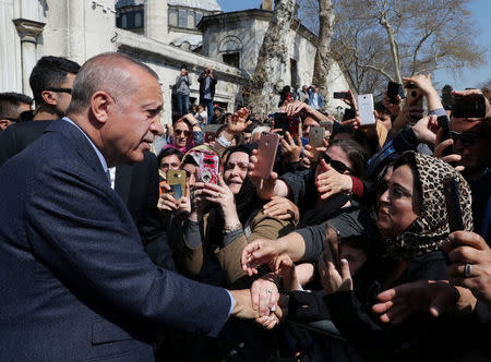 Turkish President Tayyip Erdogan is greeted by his supporters as he leaves a mosque after the Friday prayers in Istanbul, Turkey April 5, 2019. Cem Oksuz/Presidential Press Office/Handout via REUTERS