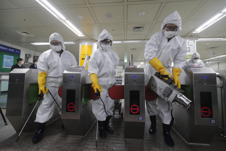 Workers wearing protective gears spray disinfectant as a precaution against the new coronavirus at a subway station in Seoul, South Korea, Friday, Feb. 28, 2020. Japan's schools prepared to close for almost a month and entertainers, topped by K-pop superstars BTS, canceled events as a virus epidemic extended its spread through Asia into Europe and on Friday, into sub-Saharan Africa.&nbsp; (Photo: Ahn Young-joon/AP)