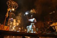 In this Monday, March 31, 2014, photo, an Indian Hindu devotee prays to the river Ganges, in Varanasi, India. For tens of millions of people, the city of Varanasi, on the banks of the river Ganges, is a place of pilgrimage, where devout Hindus believe they earn instant salvation. But in recent weeks Varanasi also has become the noisy battleground for India's most-watched contest in its national elections: Two of the country’s most prominent politicians are facing off in a contest for the city’s sole parliamentary seat. (AP Photo /Manish Swarup)