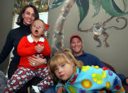 <p>Brett Favre kids around with, Charly Green, 7, while his wife, Deanna, holds Kary Camille Helveston, 5, during a visit to the Association for Retarded Children in Hattiesburg, Mississippi, in 2003. Farve announced his retirement on Tuesday, March 4, 2008, after a 17-year NFL career. (Photo by David Purdy/Biloxi Sun Herald/MCT via Getty Images)</p>