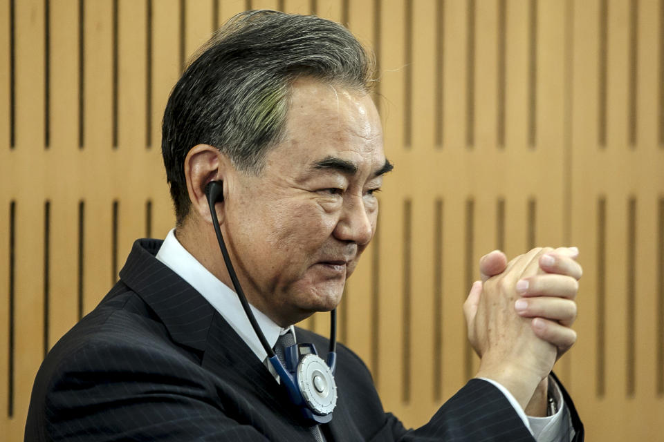 Chinese Foreign Minister Wang Yi greets the audience prior a press conference at the Institute for International Relations in Paris, Sunday, Aug. 30, 2020. Chinese Foreign Minister Wang Yi is in France as part of a five-country trip to Europe, his first since the coronavirus pandemic. (AP Photo/Kamil Zihnioglu)