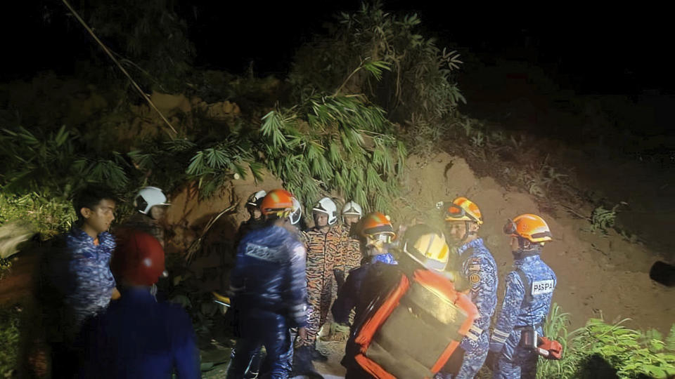 This photo released by Korporat JBPM shows rescuers work, following a landslide at a campsite in Batang Kali, Selangor state, on the outskirts of Kuala Lumpur, Malaysia, Dec. 16, 2022. (Korporat JBPM via AP)