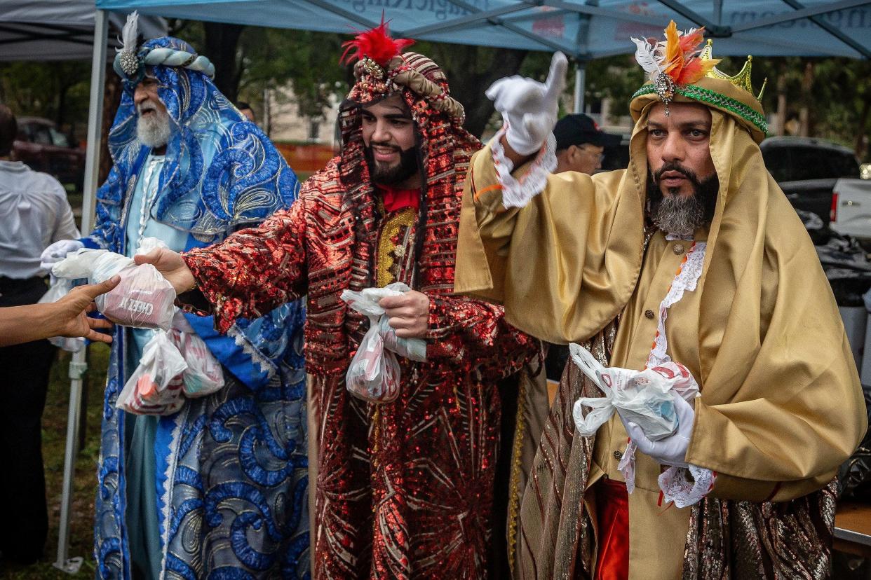 The Three Kings distribute gifts during the Fiesta de Pueblo-Three Kings Day celebration on Saturday.