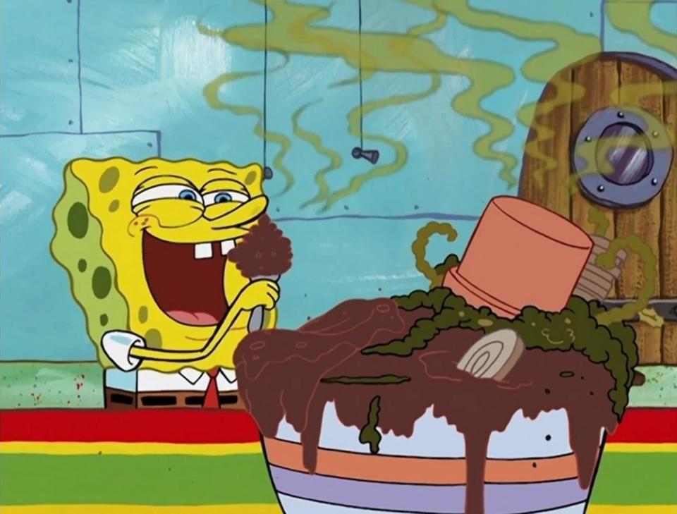 SpongeBob SquarePants sitting, eating a sundae with a large smile