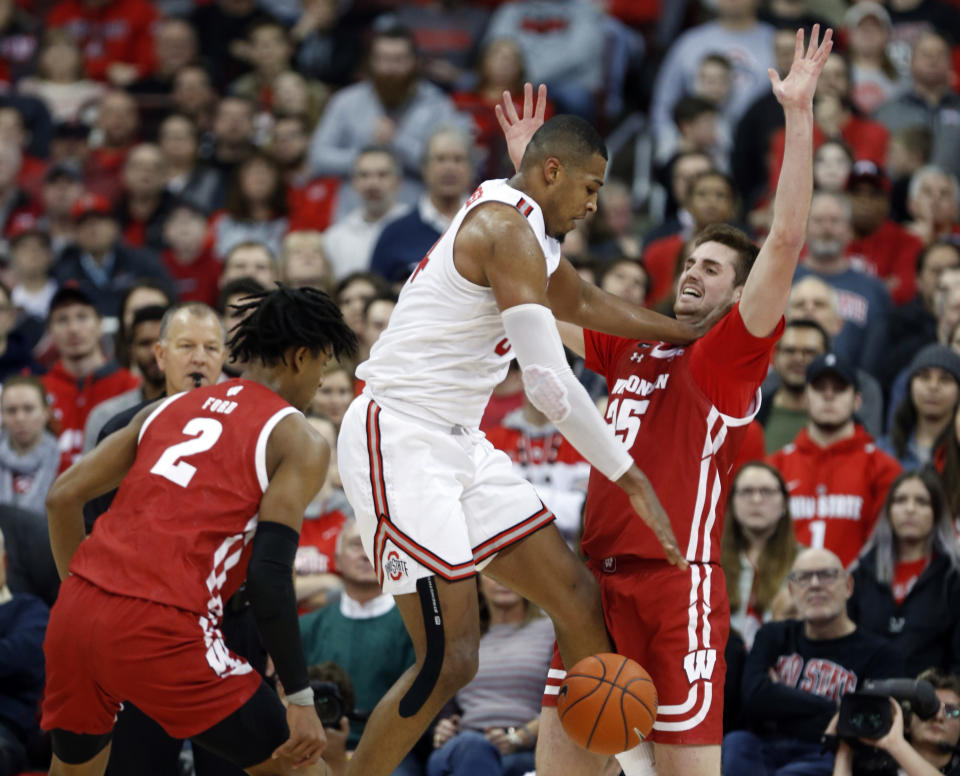 Ohio State forward Kaleb Wesson, center, loses the ball between Wisconsin forwards Aleem Ford, left, and Nate Reuvers during the first half of an NCAA college basketball game in Columbus, Ohio, Friday, Jan. 3, 2020. (AP Photo/Paul Vernon)