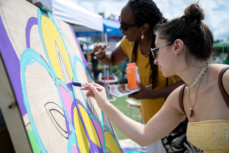 Kimberly Holmes, left, and Angelina Rodriguez paint a flower and peace sign at the 14th Annual Southwest Florida Peace Day at Wa-Ke Hatchee Park in Fort Myers on Sunday, Sept. 19, 2021.