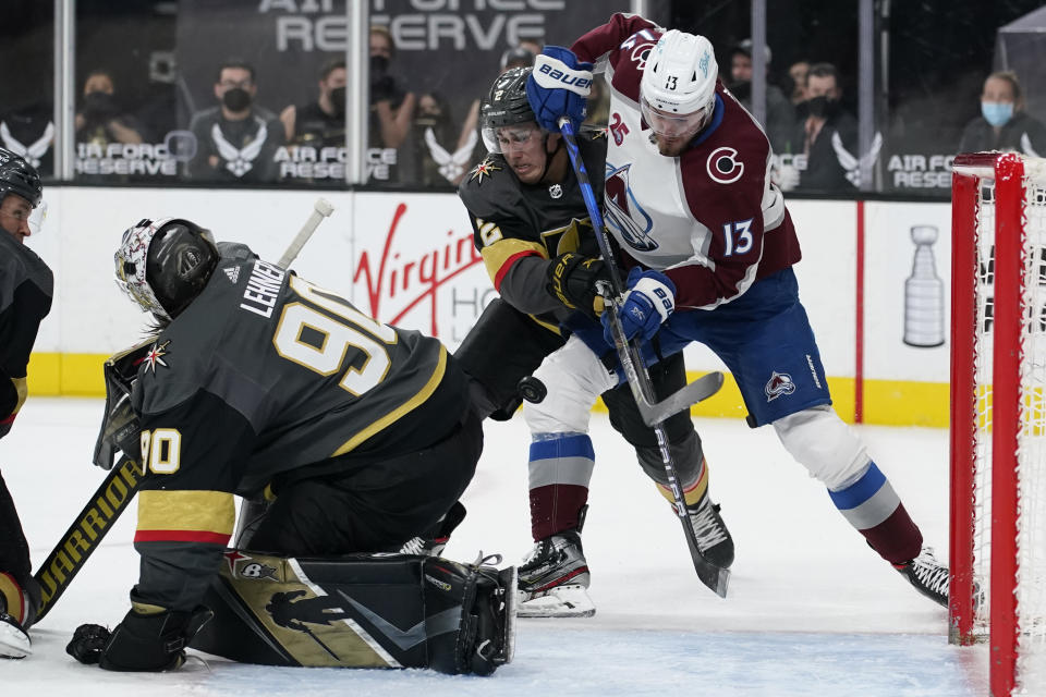 Colorado Avalanche right wing Valeri Nichushkin (13) attempts a shot against Vegas Golden Knights defenseman Zach Whitecloud (2) during the third period of an NHL hockey game Monday, May 10, 2021, in Las Vegas. (AP Photo/John Locher)