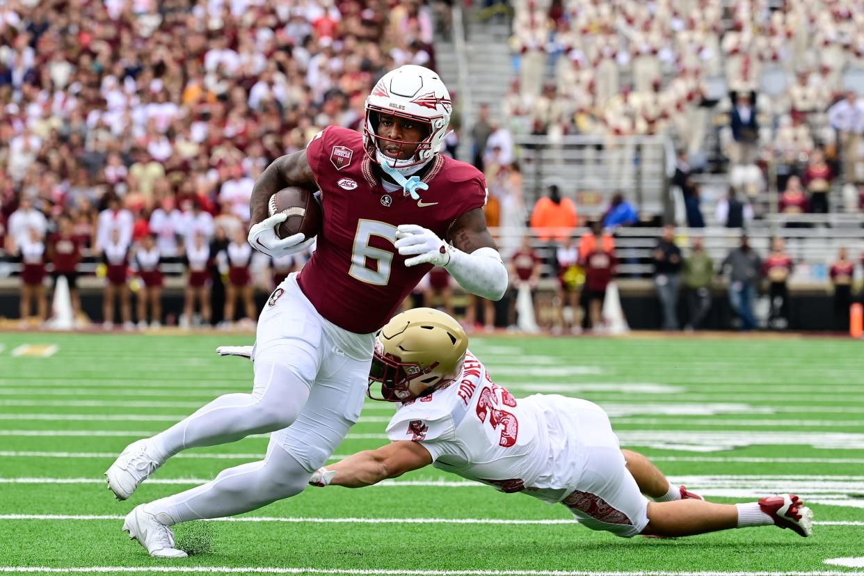 Florida State tight end Jaheim Bell (6) breaks a tackle by Boston College defensive back John Pupel (35) during the first half at Alumni Stadium.