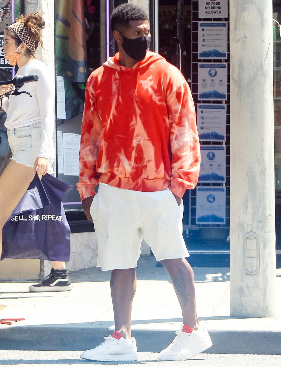 <p>Usher takes a stroll in Los Angeles on Sunday in an orange tie-dye hoodie. </p>