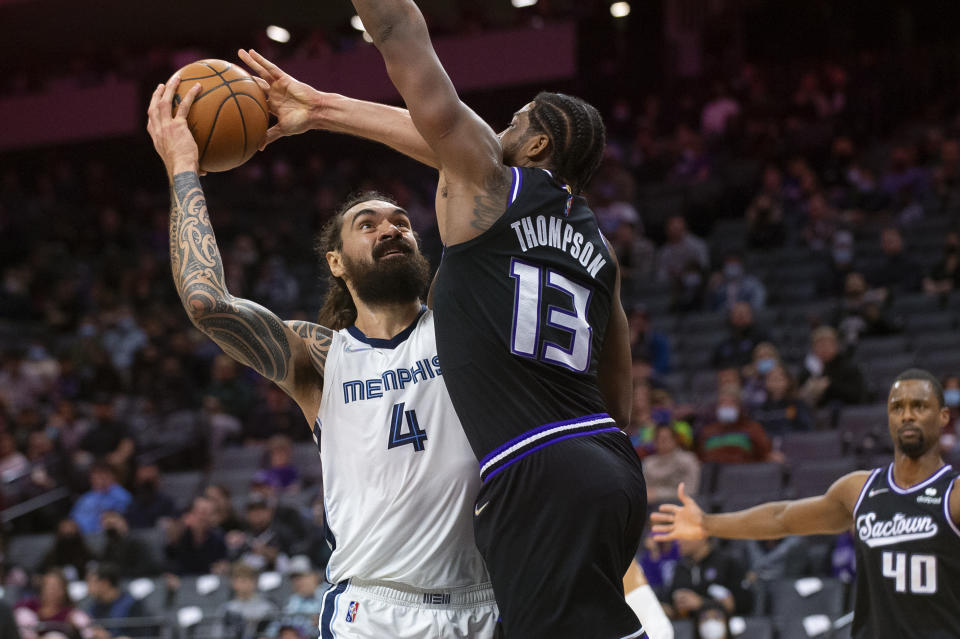 Memphis Grizzlies center Steven Adams (4) drives to the basket as Sacramento Kings center Tristan Thompson (13) defends during the first quarter of an NBA basketball game in Sacramento, Calif., Friday, Dec. 17, 2021. (AP Photo/Randall Benton)