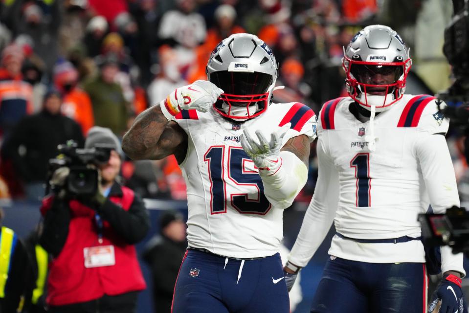 Dec 24, 2023; Denver, Colorado, USA; New England Patriots running back Ezekiel Elliott (15) celebrates scoring a touchdown in the third quarter against the Denver Broncos at Empower Field at Mile High. Mandatory Credit: Ron Chenoy-USA TODAY Sports