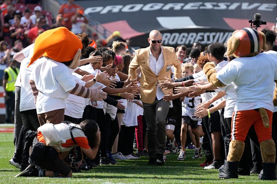 Former Cleveland Browns player Joe Thomas takes the field before being inducted into the football team's Ring of Honor and receiving his Pro Football Hall of Fame ring of excellence during halftime of an NFL football game against the Baltimore Ravens, Sunday, Oct. 1, 2023, in Cleveland. (AP Photo/Sue Ogrocki)