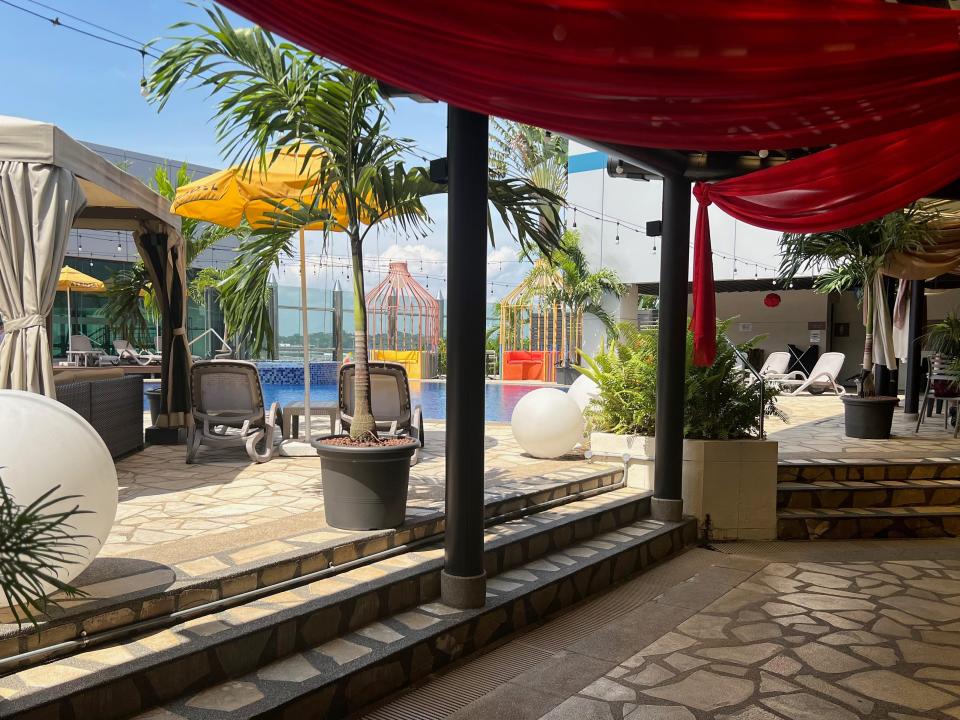 The pool area at Changi's terminal 1 with cabana and chairs.