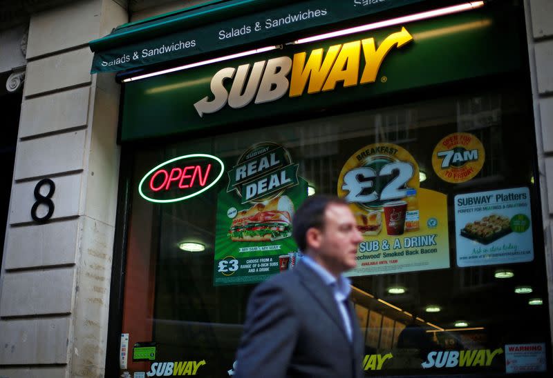 FILE PHOTO: A man walks past a Subway sandwich store in central London
