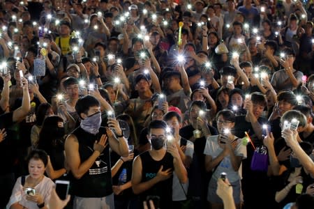 People hold up mobile phones during the Mid-Autumn Festival, in Sha Tin, Hong Kong