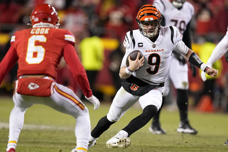 Cincinnati Bengals quarterback Joe Burrow (9) runs against Kansas City Chiefs safety Bryan Cook (6) during the second half of the NFL AFC Championship playoff football game, Sunday, Jan. 29, 2023, in Kansas City, Mo. (AP Photo/Brynn Anderson)