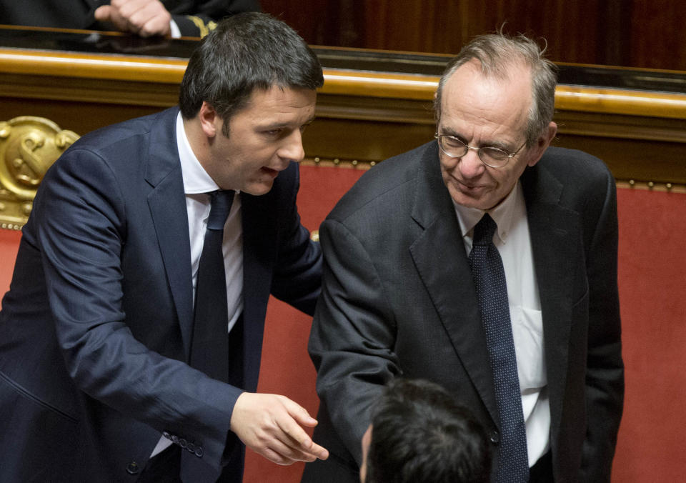 Premier Matteo Renzi, left, talks with Finace minister Pier Carlo Padoan as he arrives to deliver his speech prior to a confidence vote, at the Senate, in Rome, Monday, Feb. 24, 2014. Renzi, Italy's youngest premier, is heading a new government he says promises will swiftly tackle old problems.(AP Photo/Andrew Medichini)