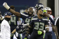 Seattle Seahawks' Jamal Adams (33) and L.J. Collier, left, celebrate after the Seahawks beat the New England Patriots 35-30 in an NFL football game, Sunday, Sept. 20, 2020, in Seattle. (AP Photo/John Froschauer)