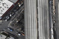 The site of a fire is seen under Interstate 10, Monday, Nov. 13, 2023, in Los Angeles. Los Angeles drivers are being tested in their first commute since a weekend fire that closed a major elevated interstate near downtown. (AP Photo/Jae C. Hong)